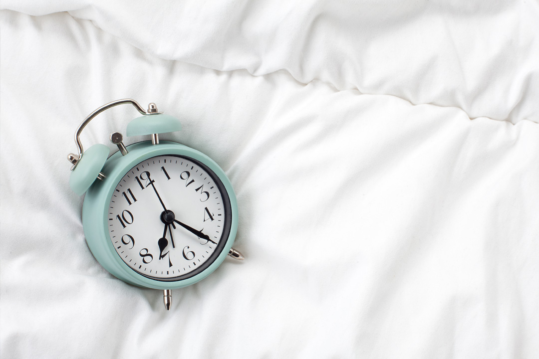 Alarm clock on bed